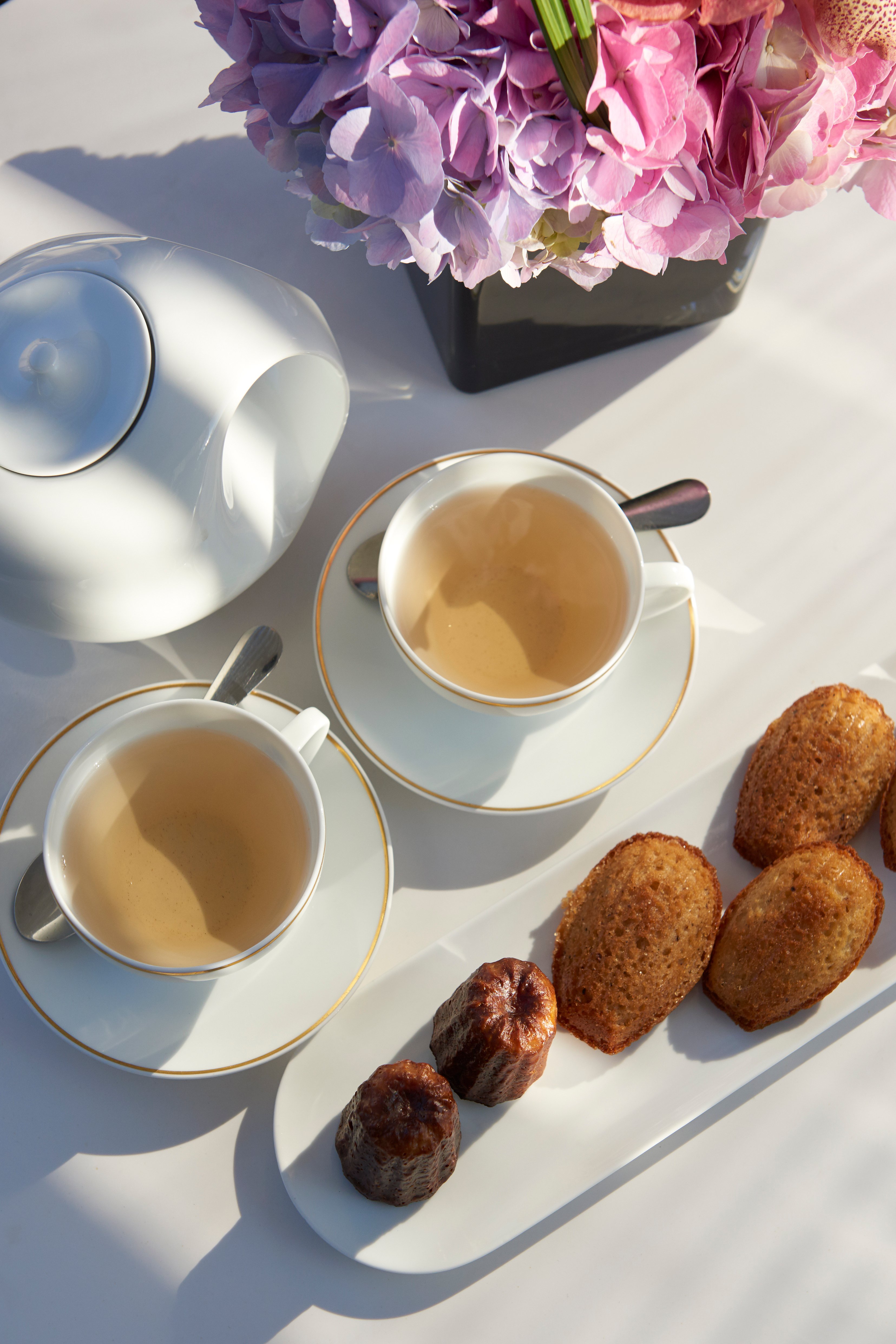 Breakfast pastries and tea on a table.
